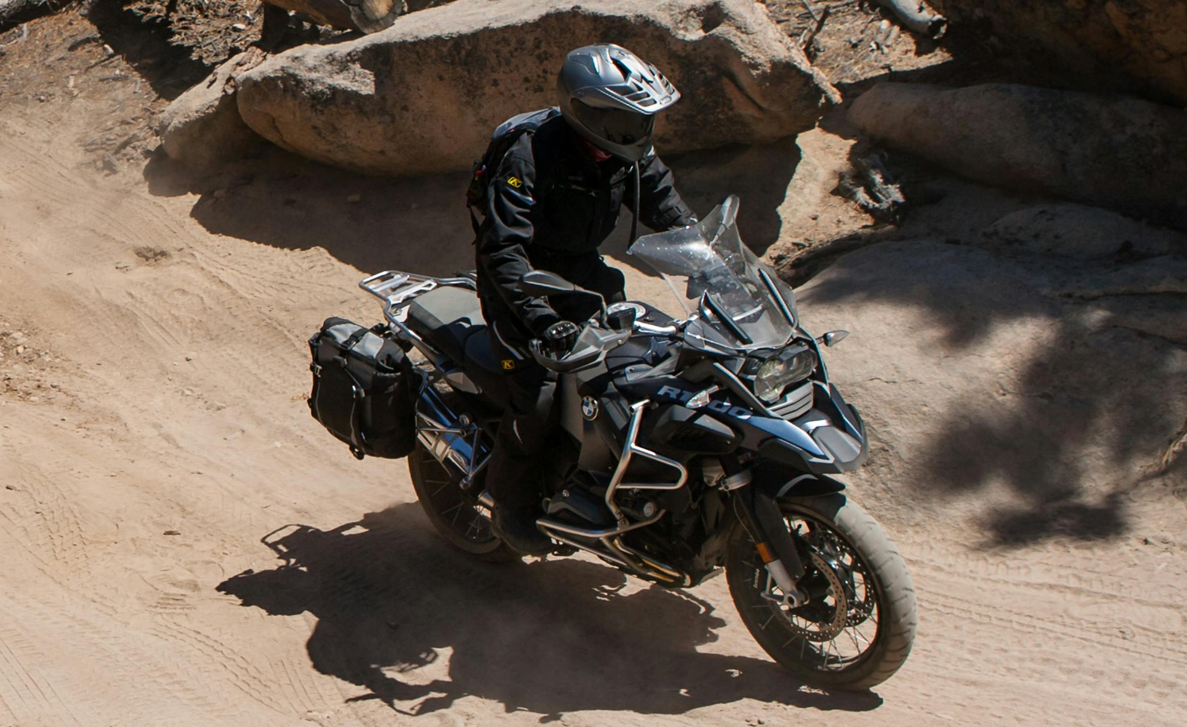 Adventure motorcycle rider on a BMW adventure motorcycle wearing all black protective gear