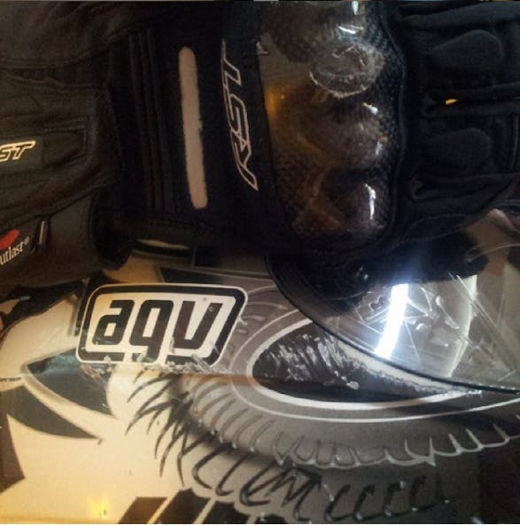 AGV helmet with scratches and dent on carbon knuckles of gloves