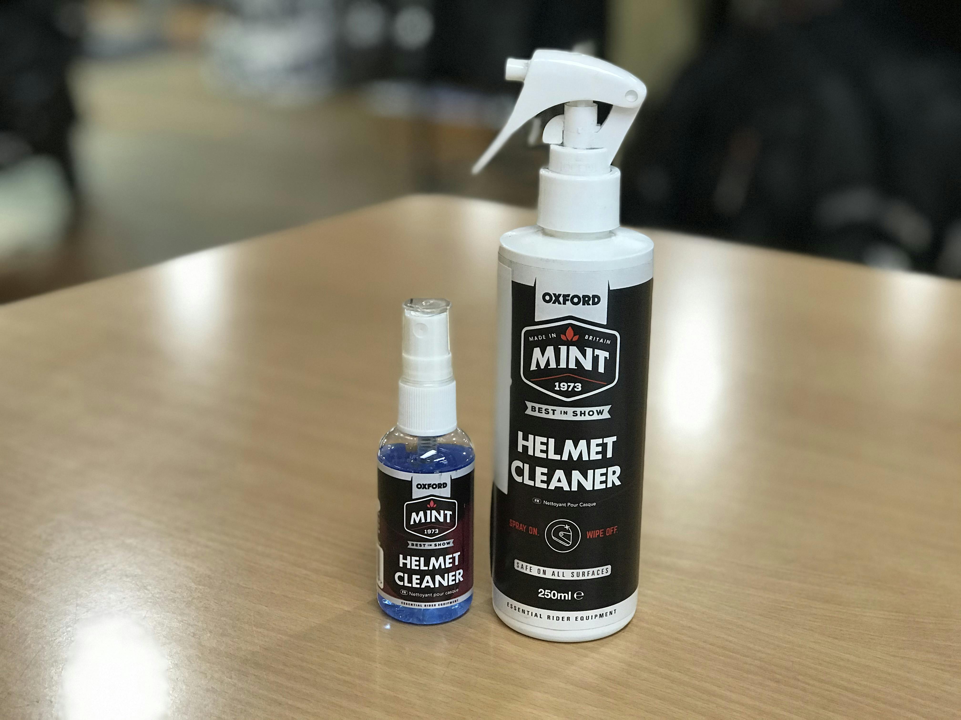 A small and big bottles of Mint Helmet cleaner