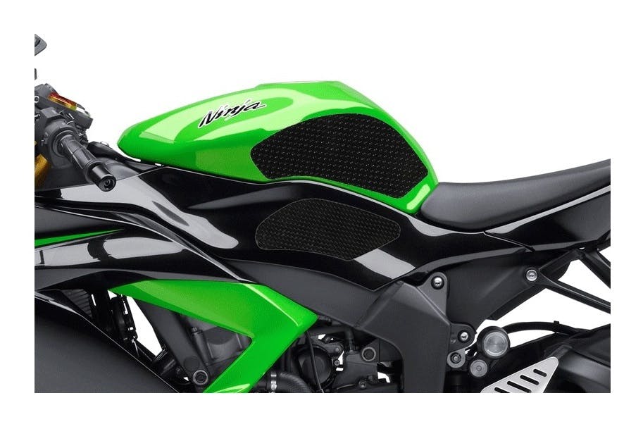 Black tank grips on a green and black Kawasaki Ninja motorcycle
