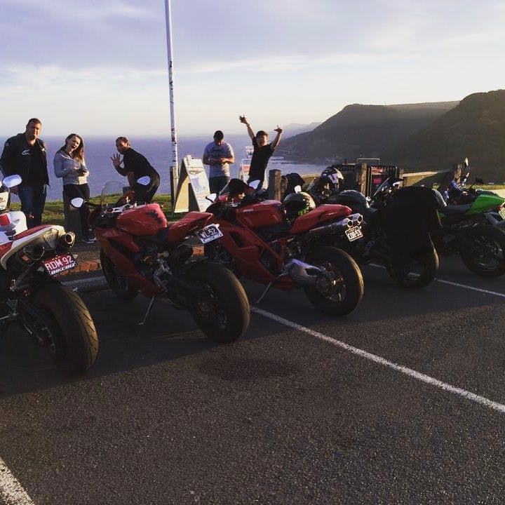 a group of motorcycle riders at the end of a ride