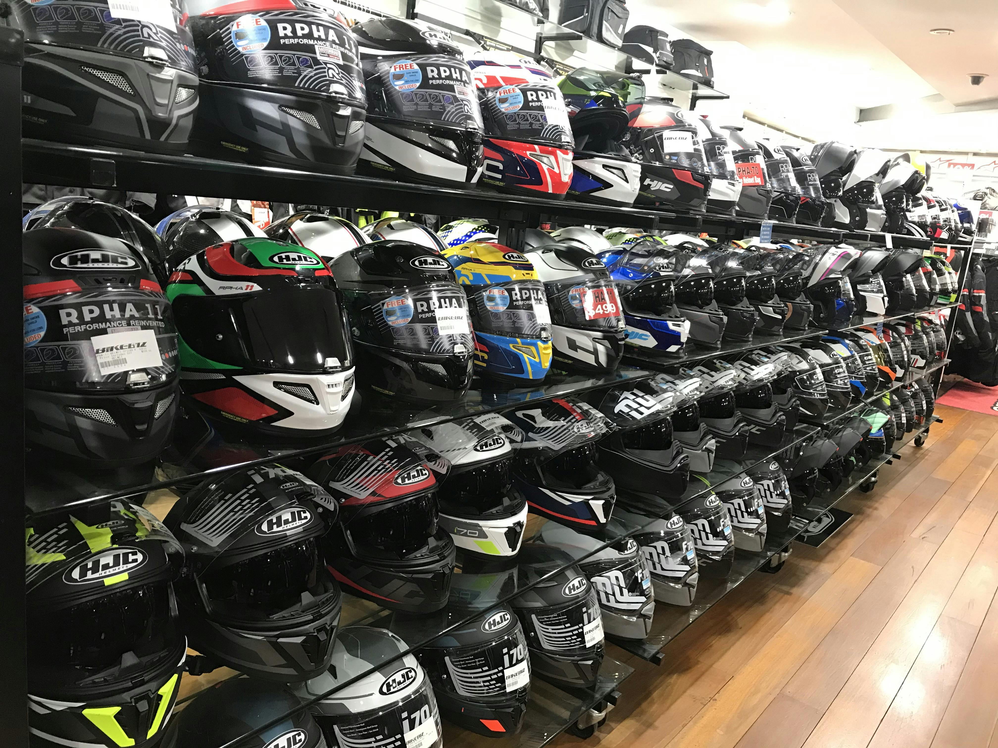 4 shelves filled with helmets
