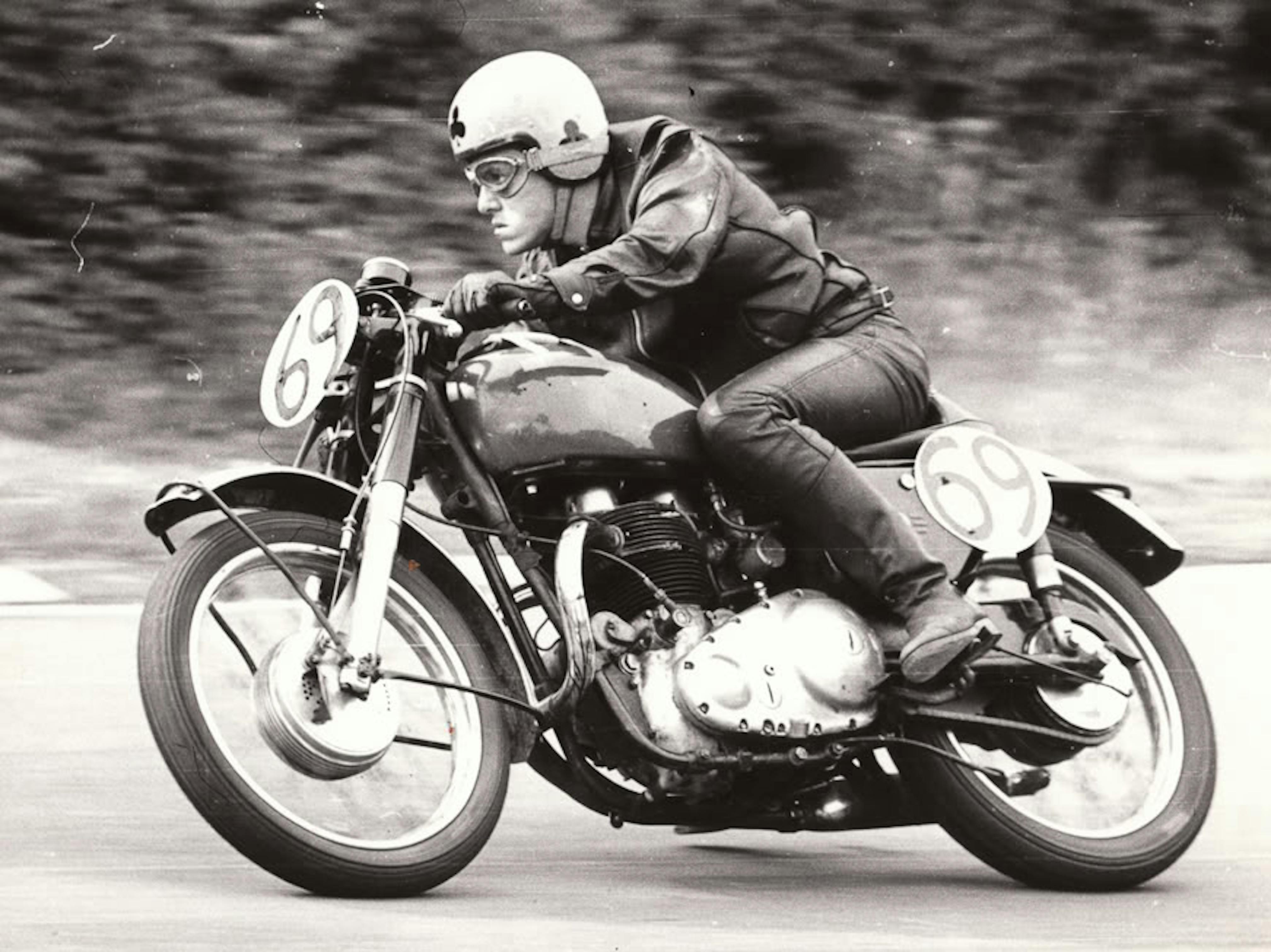 Old motorcycle racer on vintage motorcycle