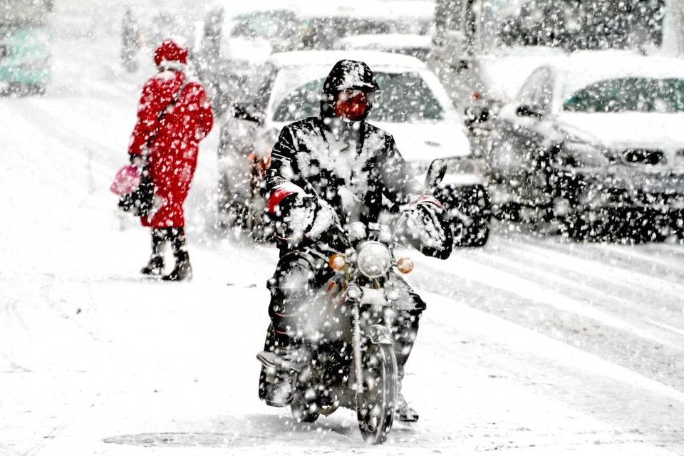 Guy riding a motorcycle in the snow