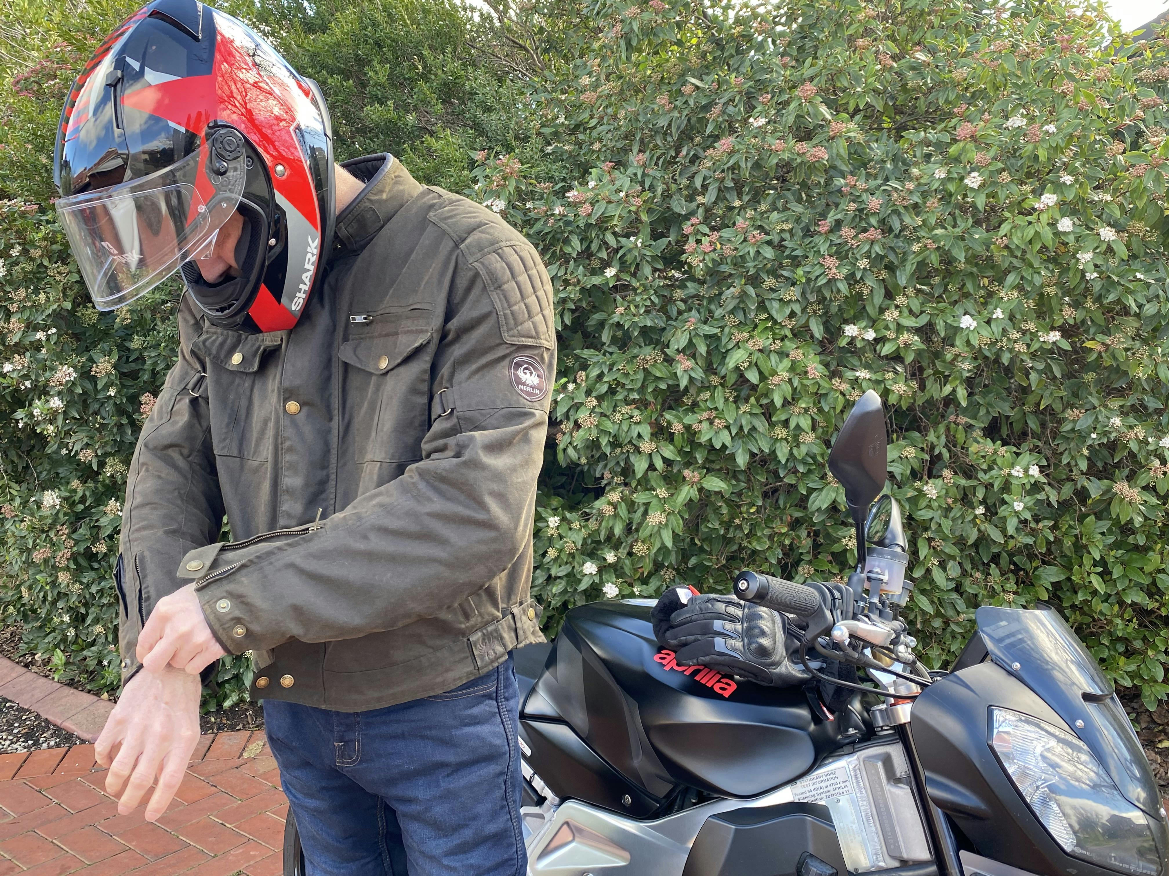 A man doing up the press studs on the wrist of a Merlon Barton Jacket