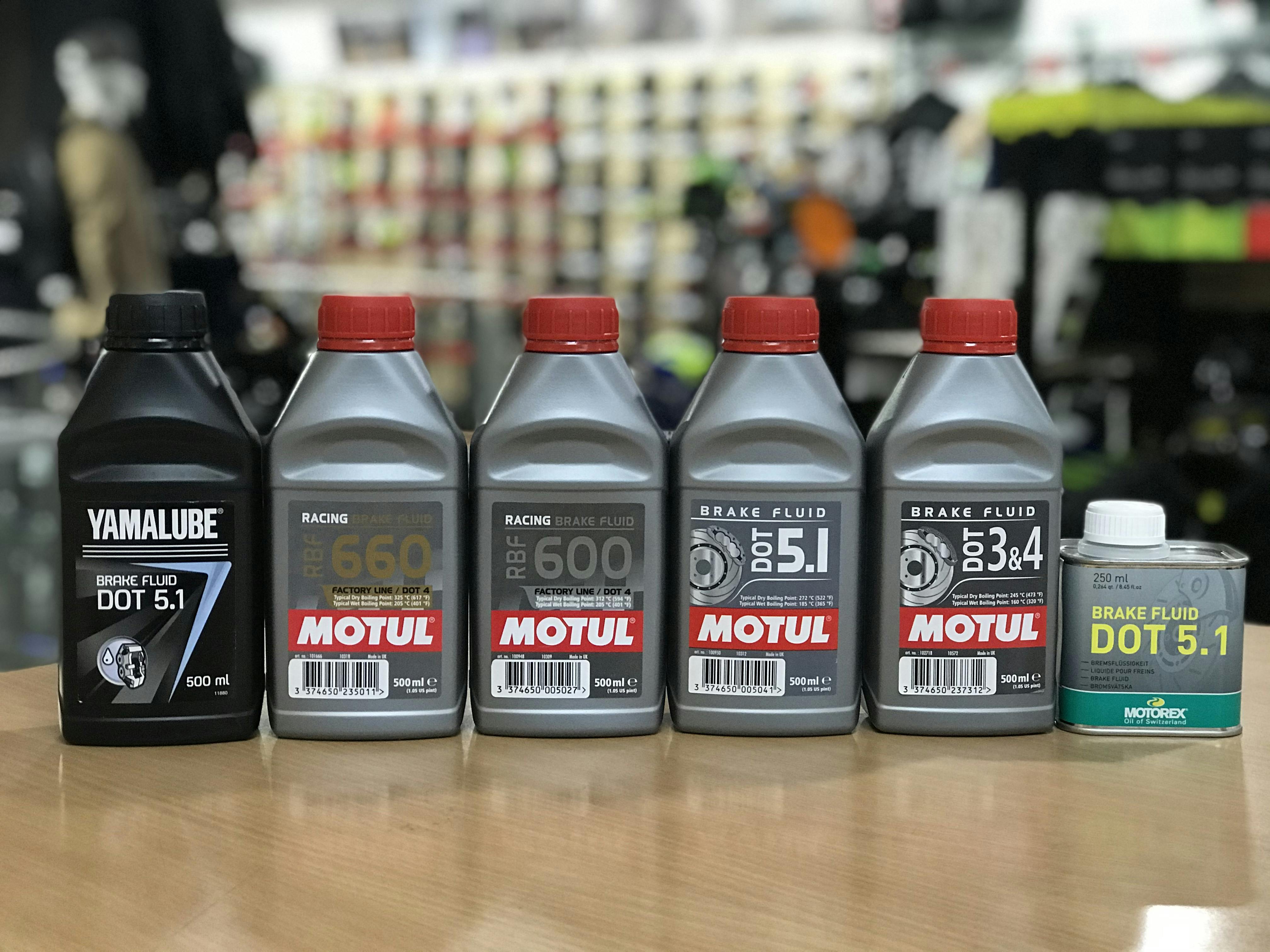 Different bottles of different types of brake fluid