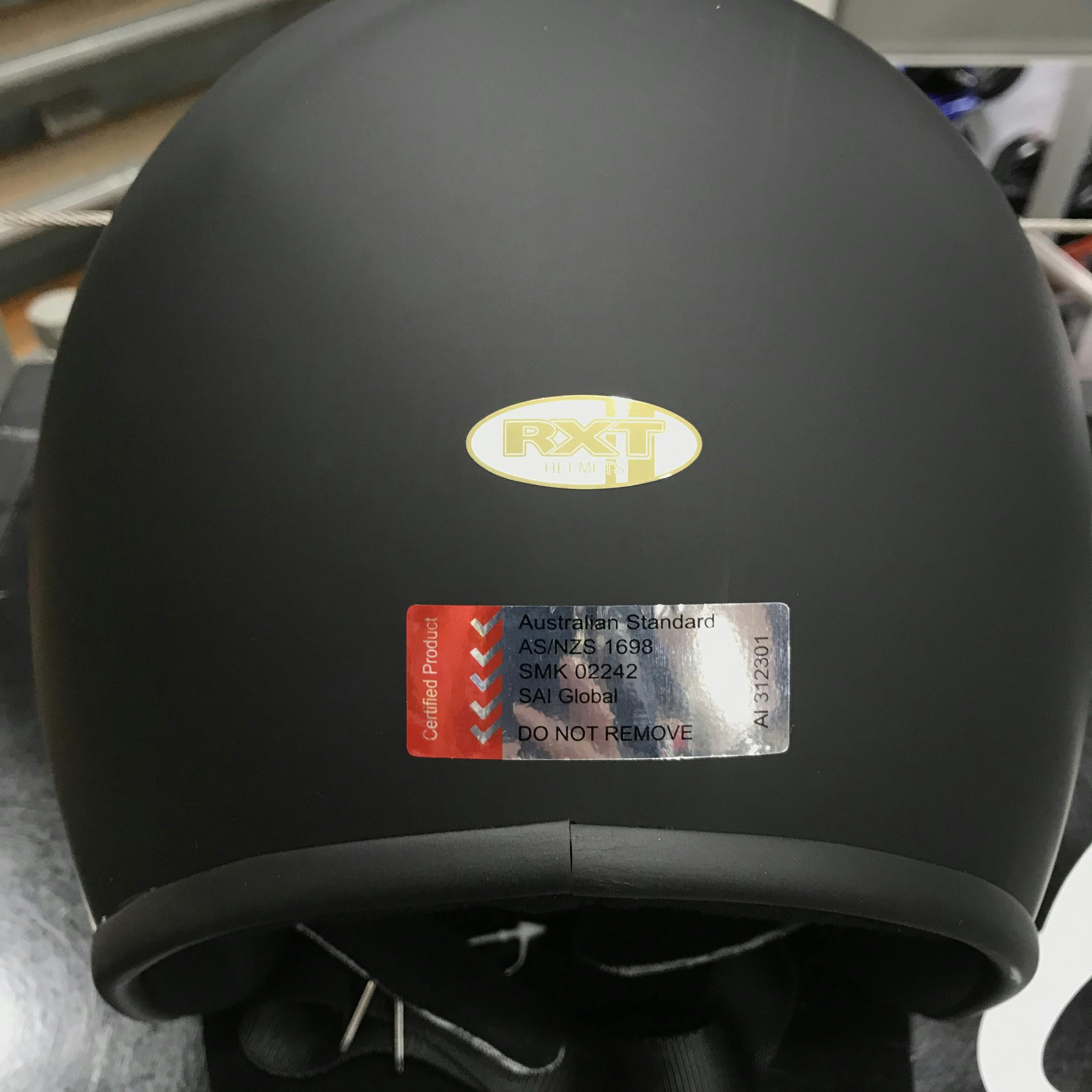 Australian Standards sticker on the back of a matte black helmet