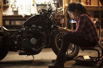 Woman working on a motorcycle