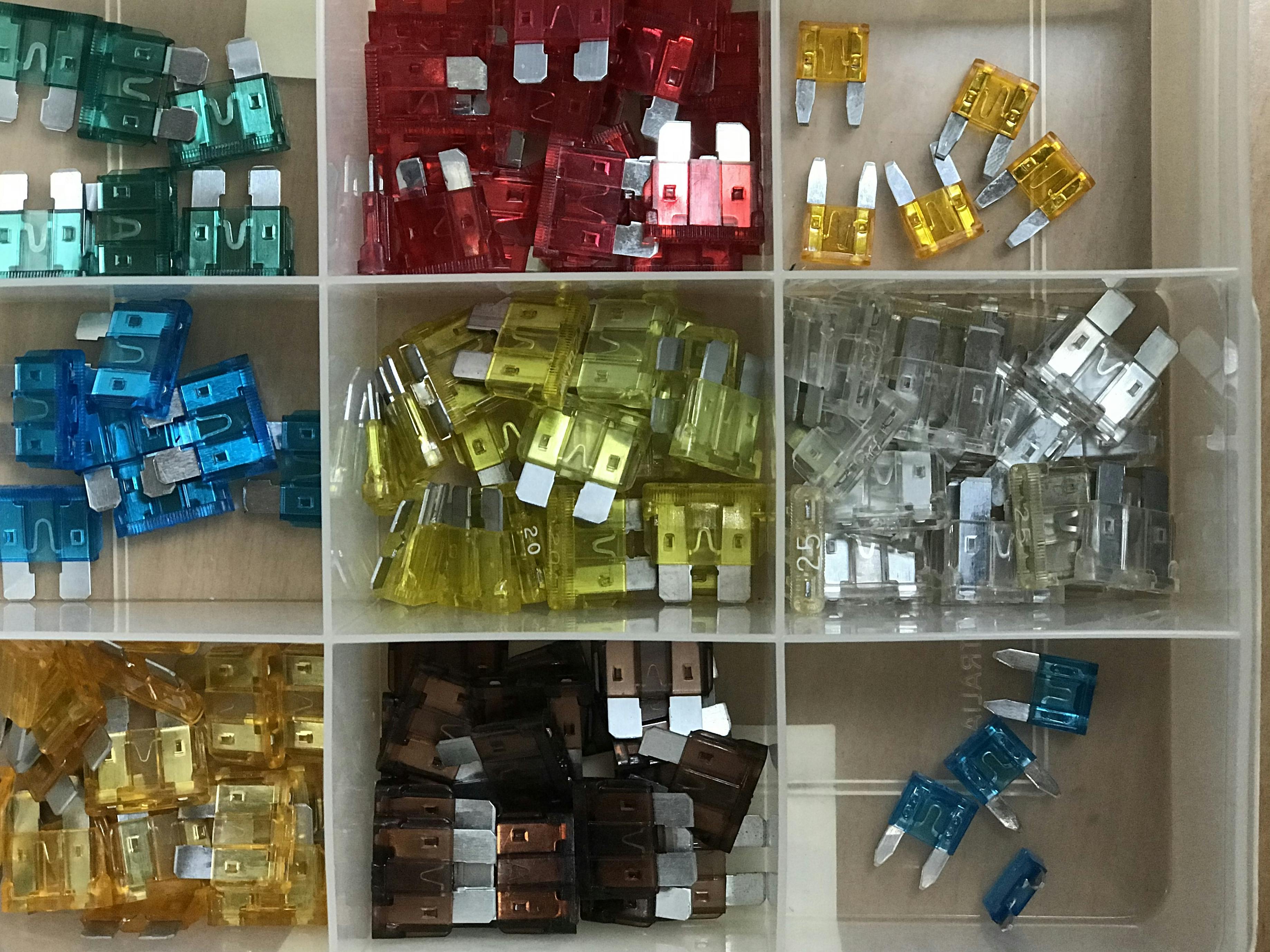 A box of different coloured fuses