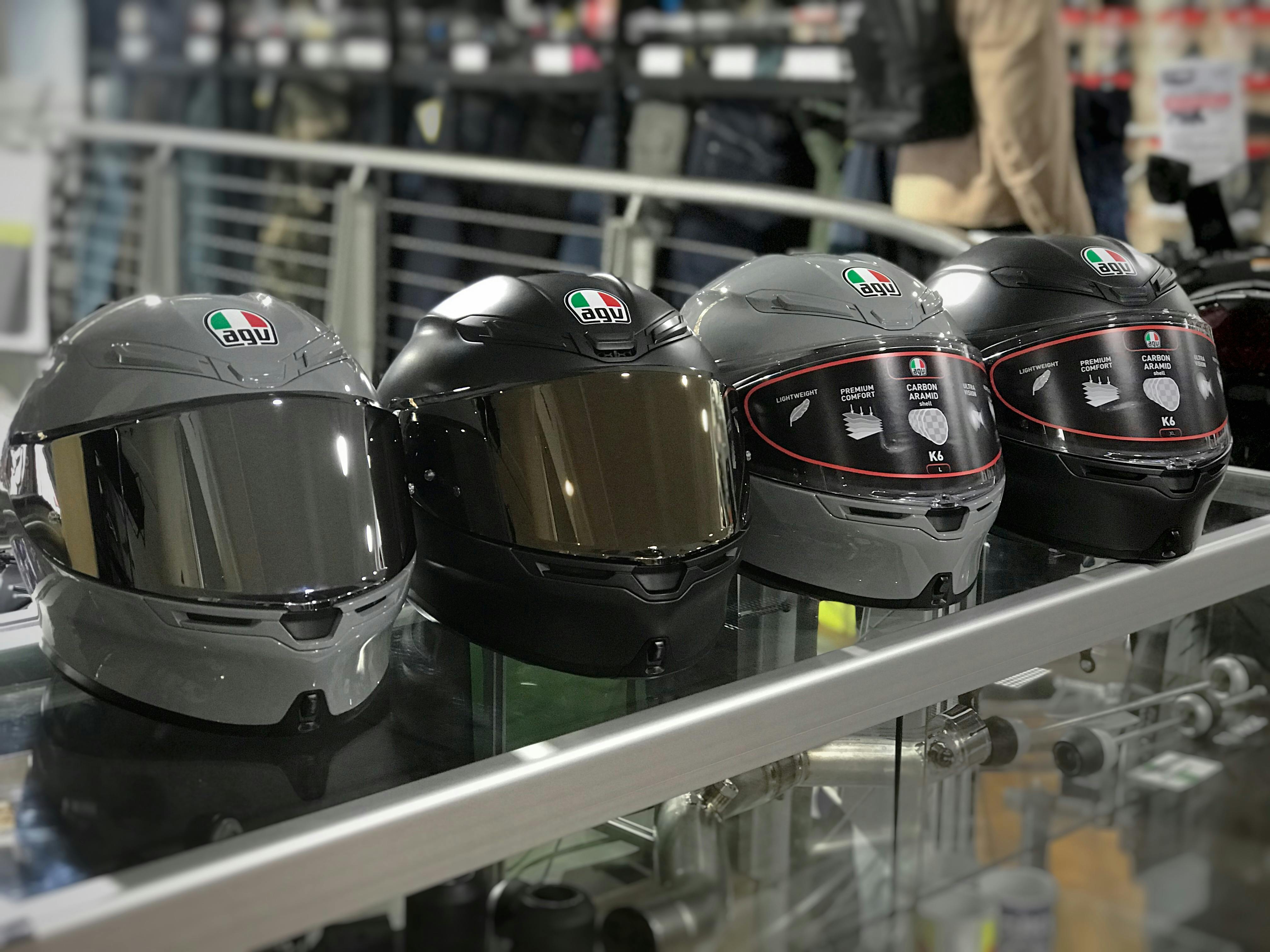 2 grey and 2 black AGV K6 road helmets