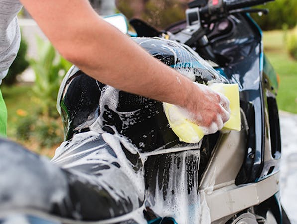 Man cleaning a motorcycle