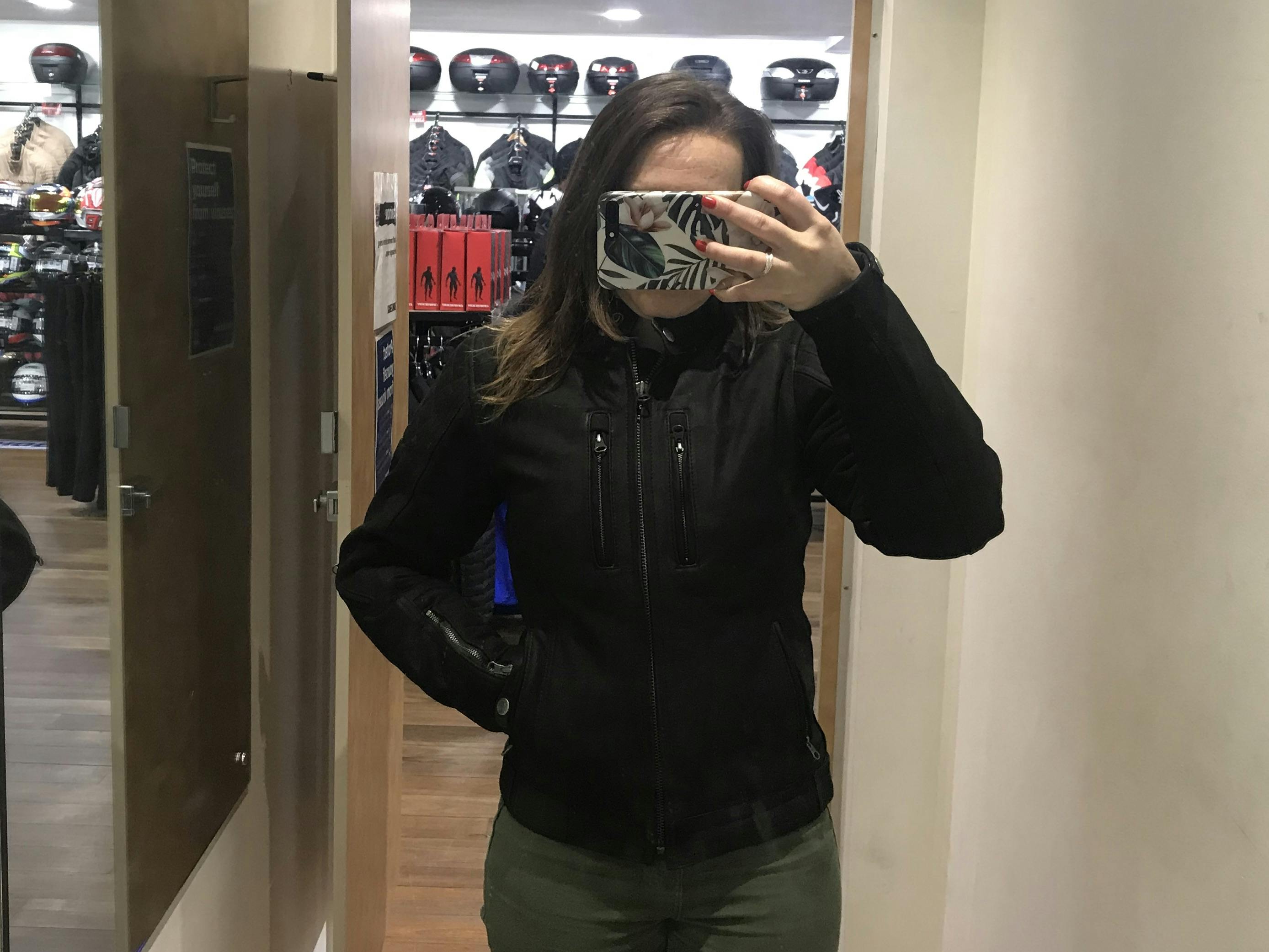 A woman in the Merlin Mia black leather motorcycle jacket