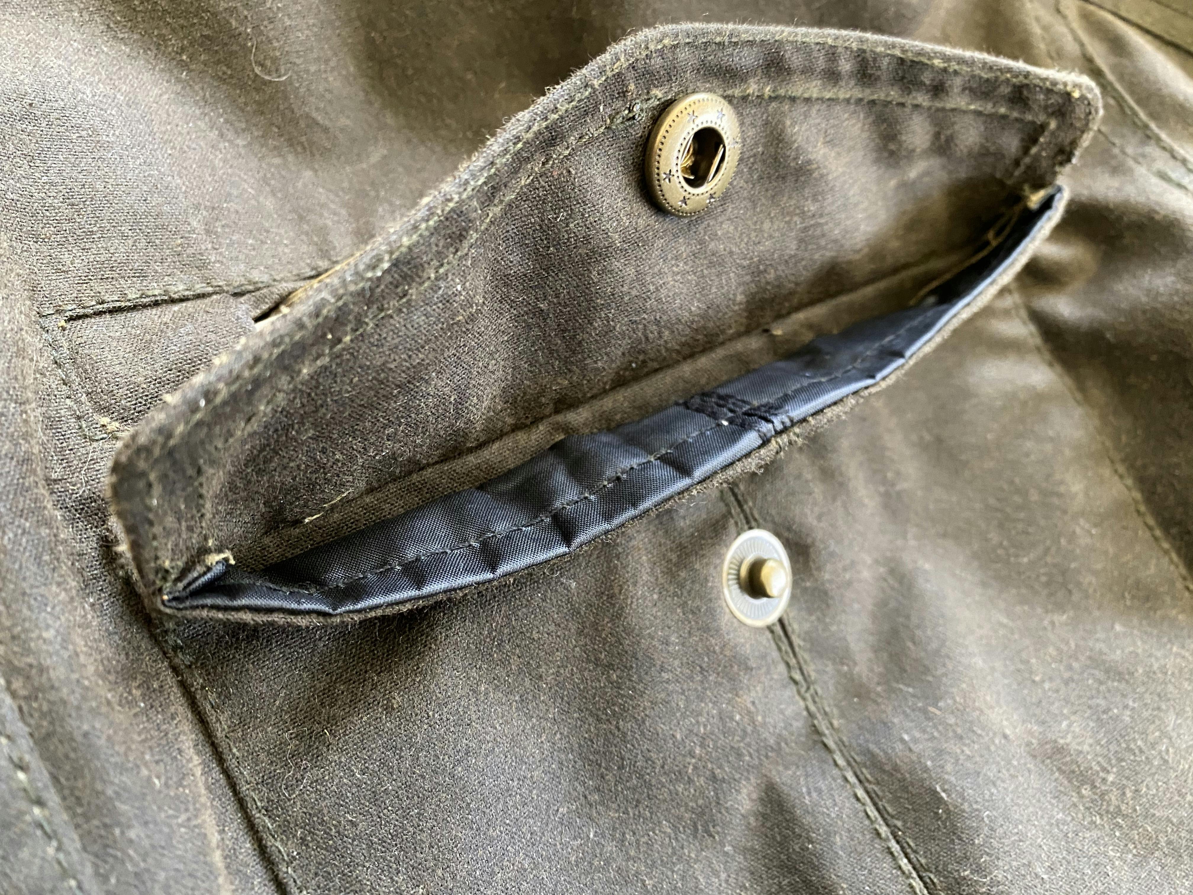 A close up of the fold over pocket on the merlin Barton Jacket