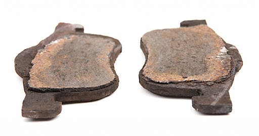 A set of worn out brake pads