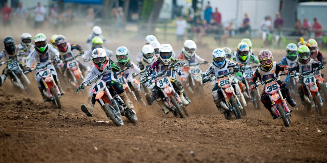 Large group of kids racing motocross