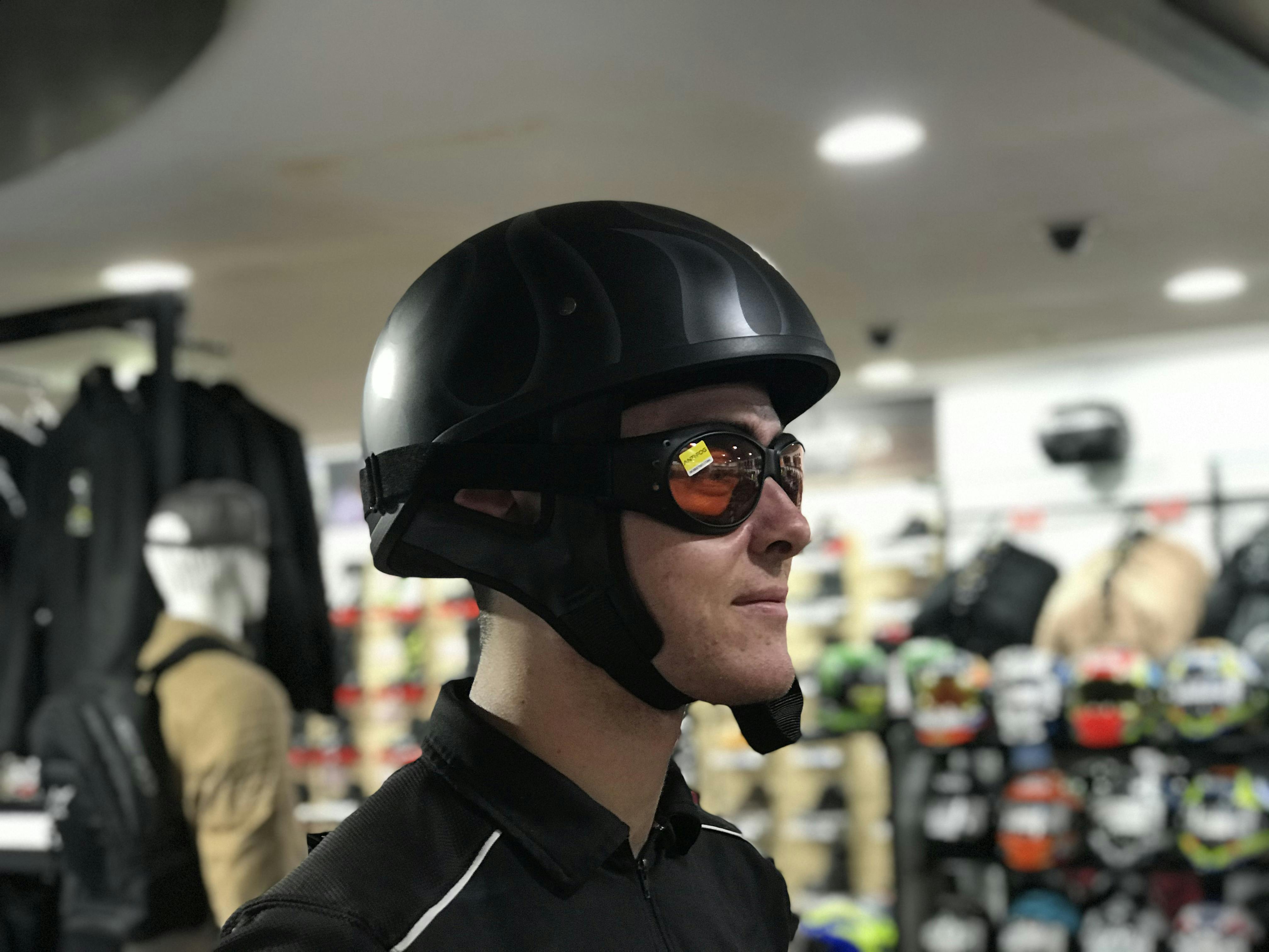 Half face helmet with orange goggles on a man