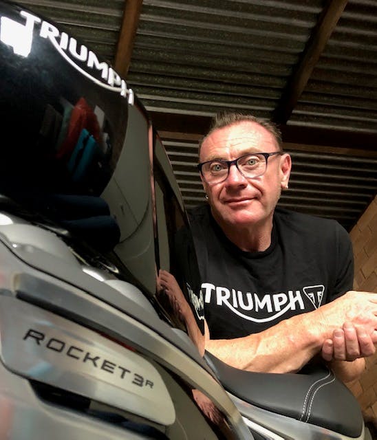 Self timer selfie of a man leaning on the seat of a Triumph Rocket 3 R