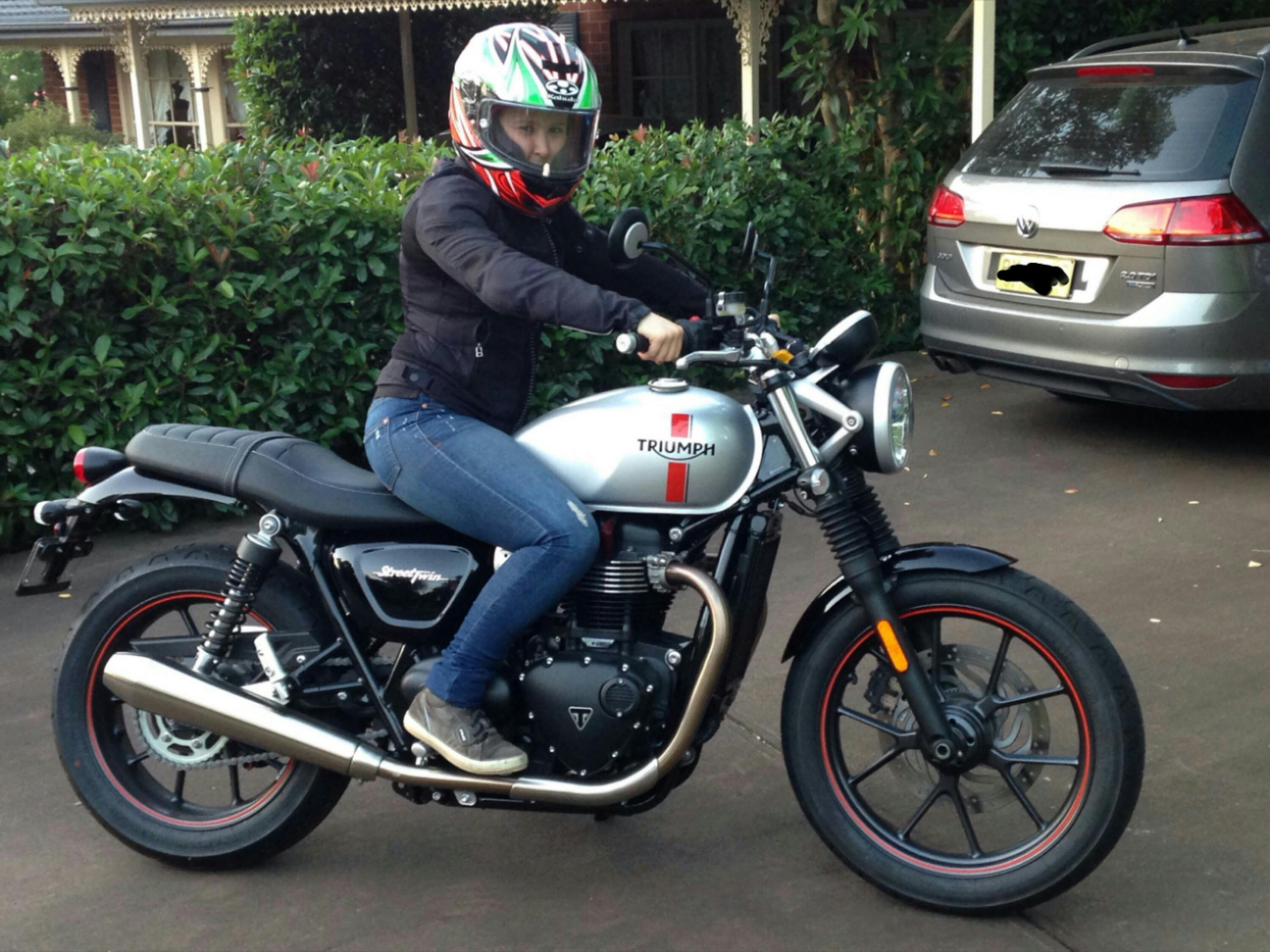 Woman on Triumph Street Twin Motorcycle with helmet and jacket