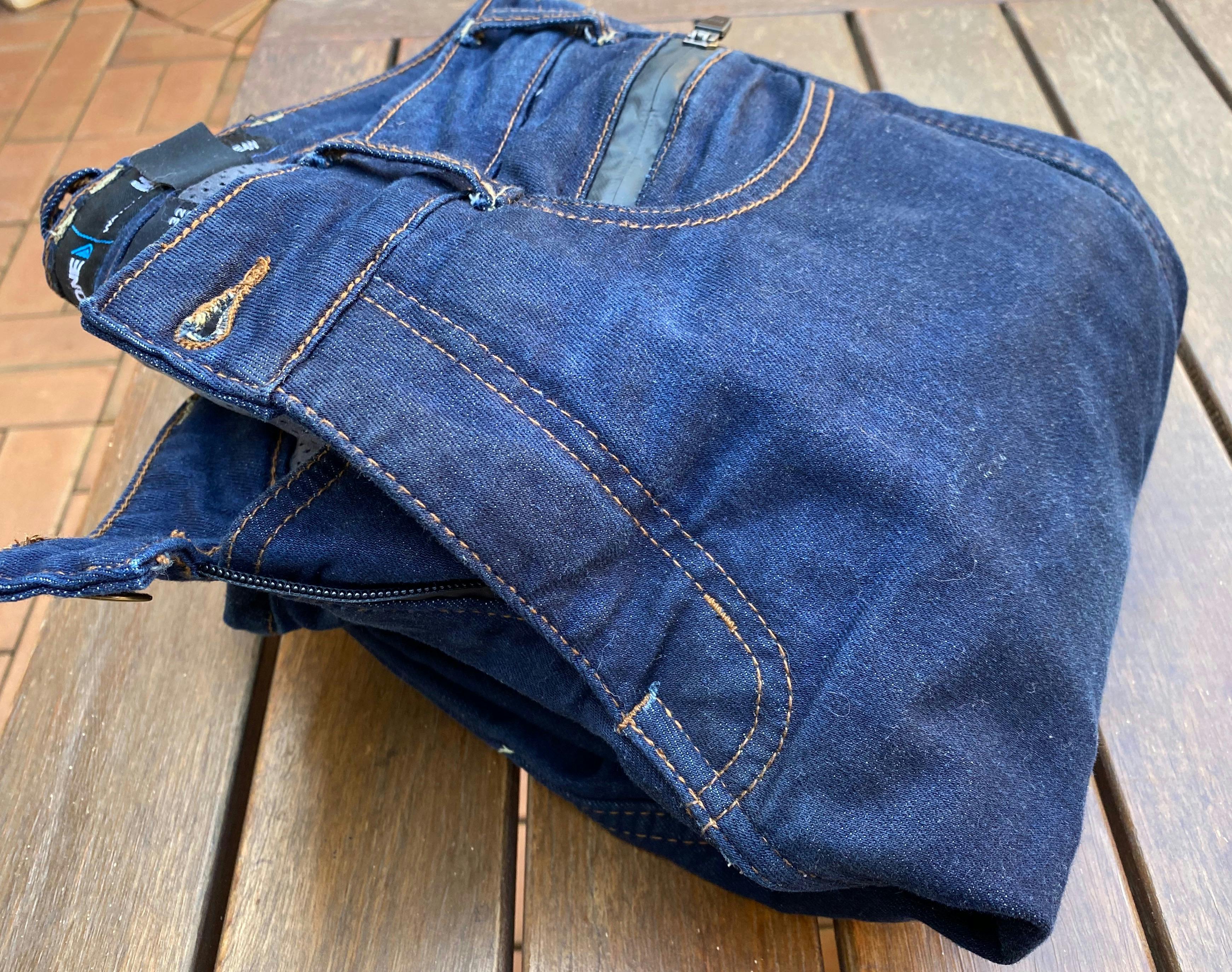 The Merlin Mason Waterproof Jean folded up on a wooden table