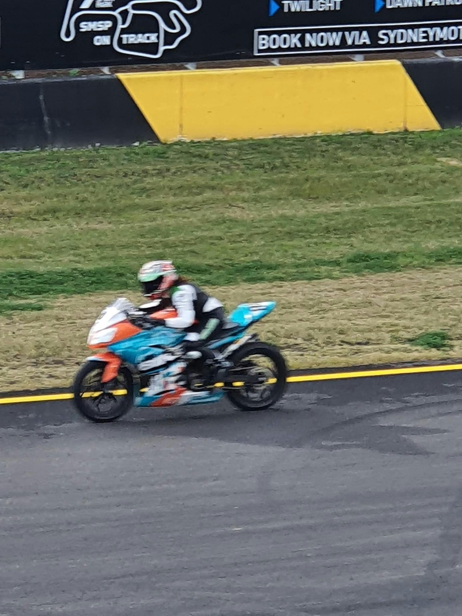 A rider with a bright helmet on a bright motorcycle