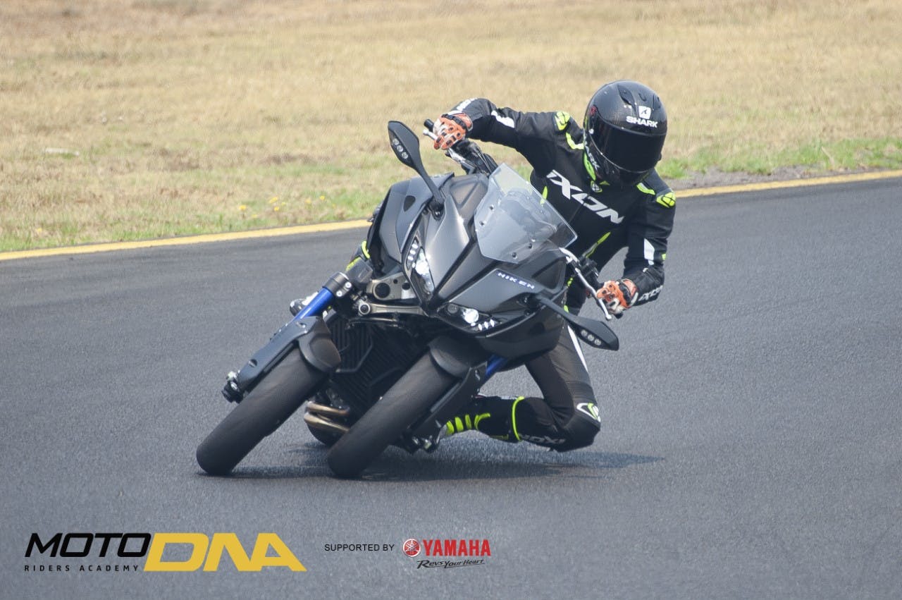 Guy  on the track in full leathers, riding a Yamaha Niken