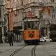 Taksim İstiklal Caddesi vintage kırmızı tramvay ve sokak görseli ikonlu biletiniz.com logosu - En uygun İstanbul otobüs ve uçak bileti karşılaştırma platformu.