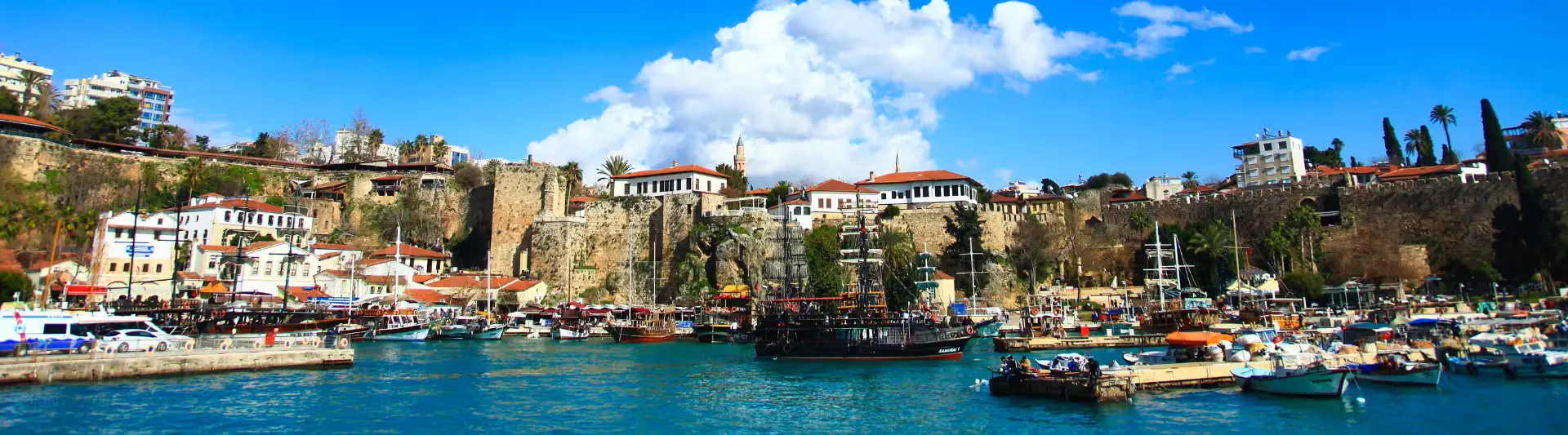 biletiniz.com - Antalya gezilecek yerler rehberi; tarihi Kaleiçi Yat Limanı (Marina), demirli yatlar ve Akdeniz manzarası eşliğinde Antalya şehir turu kapak görseli.