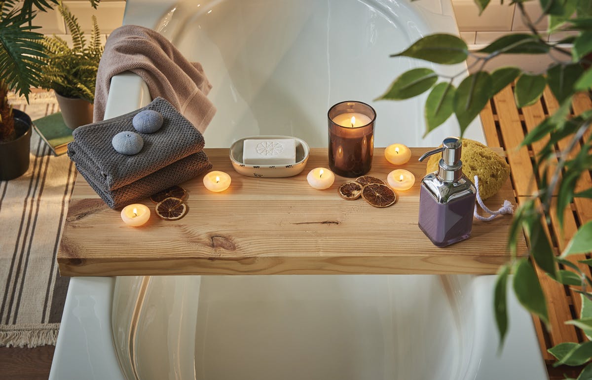 Tips to create an At-Home Spa Bathroom: Bring Everything Within Reach Wooden bathtub caddy with candles and soaps