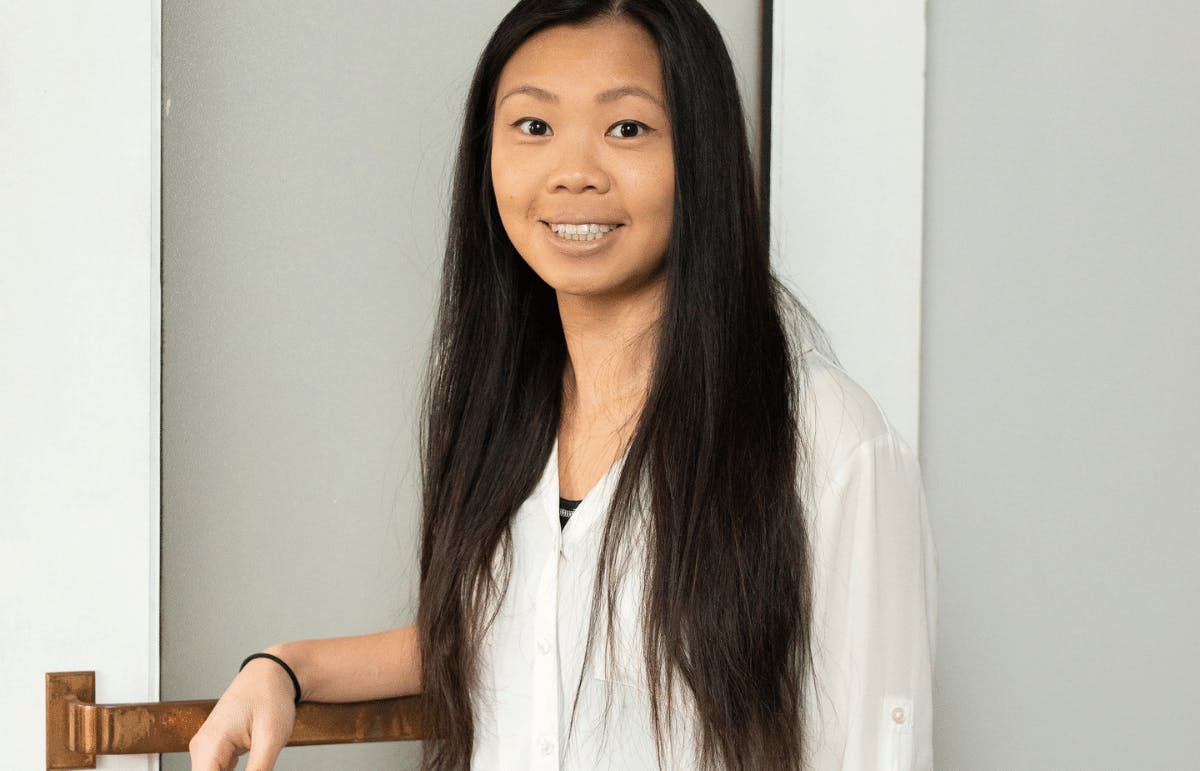 Victoria Suen, architect, leaning on a door with a brass handle Victoria Suen, architect, leaning on a door with a brass handle