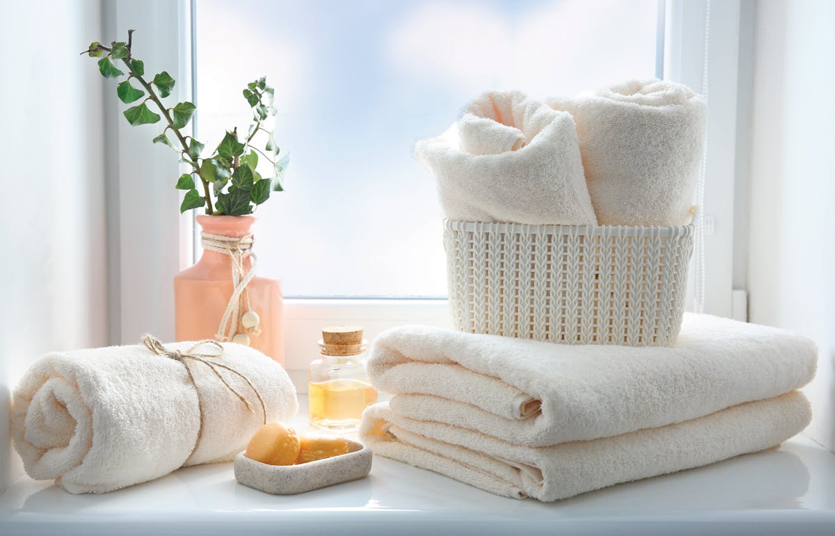 Tips to create an At-Home Spa Bathroom: Throw out Old Towels Fresh towels in bathroom window well