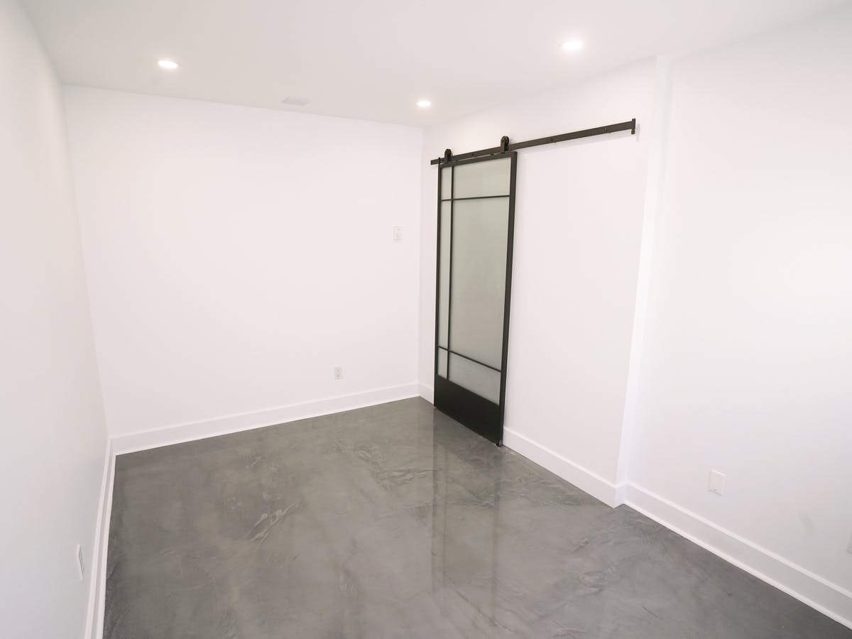Renovated basement office with French frosted barn door Renovated basement office with French frosted barn door