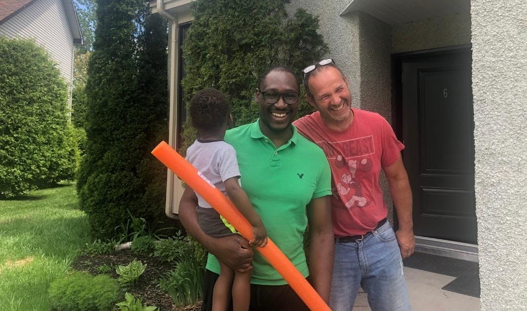 Homeowner Abraham and his son pose with general contractor, Erico Homeowner Abraham and his son pose with general contractor, Erico