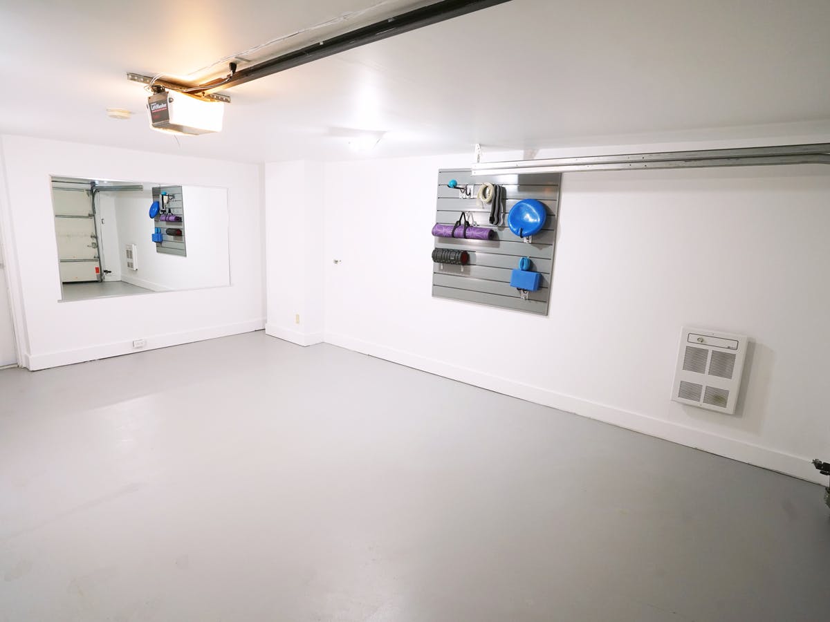 Renovated garage with workout equipment on wall Renovated garage with workout equipment on wall