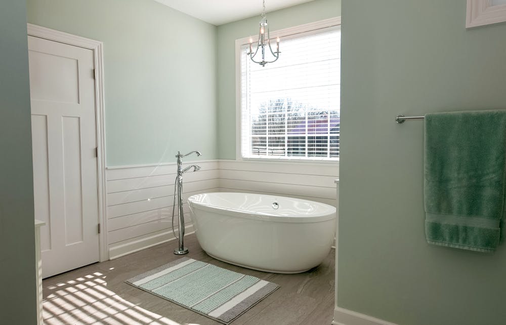 Chandelier over a free-standing tub Renovated bathroom with chandelier over bathtub