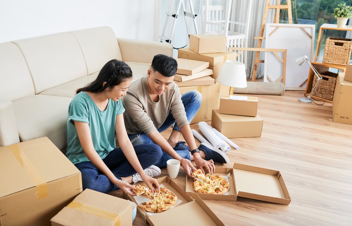 Makeshift kitchen table during renovation Eating pizza surrounded by boxes