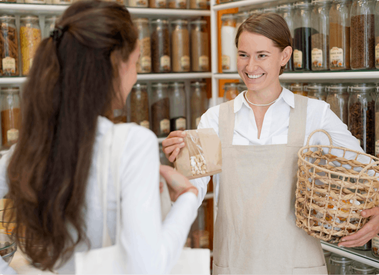 Merchant of a grocery store talking with a customer