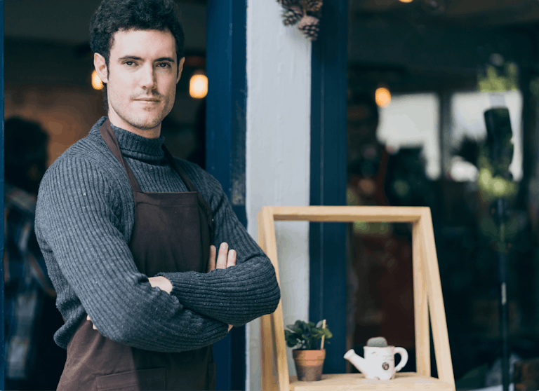 Merchant in a specialty store crossing arms