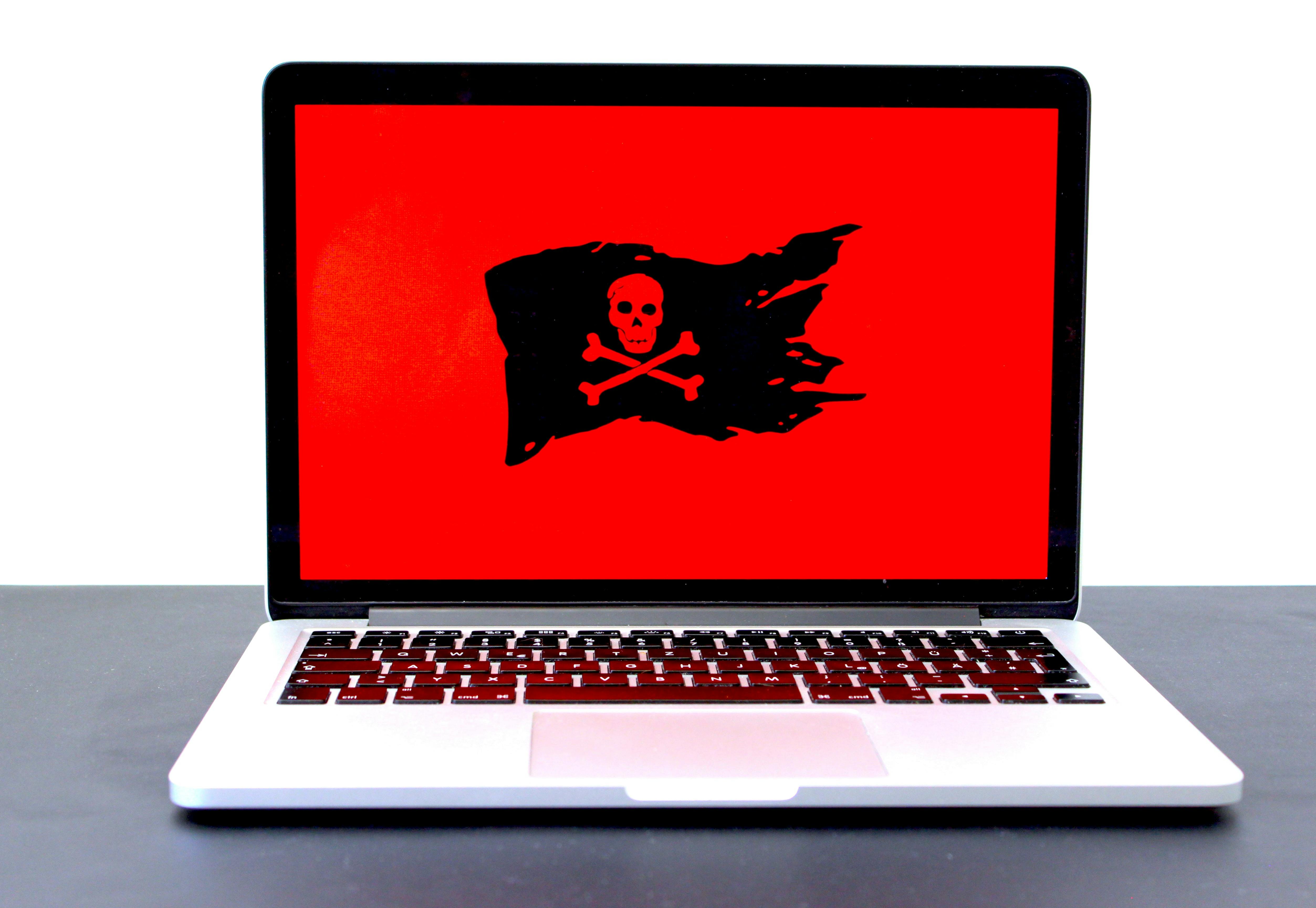 Red computer screen with pirate flag - Photo by Michael Geiger on Unsplash