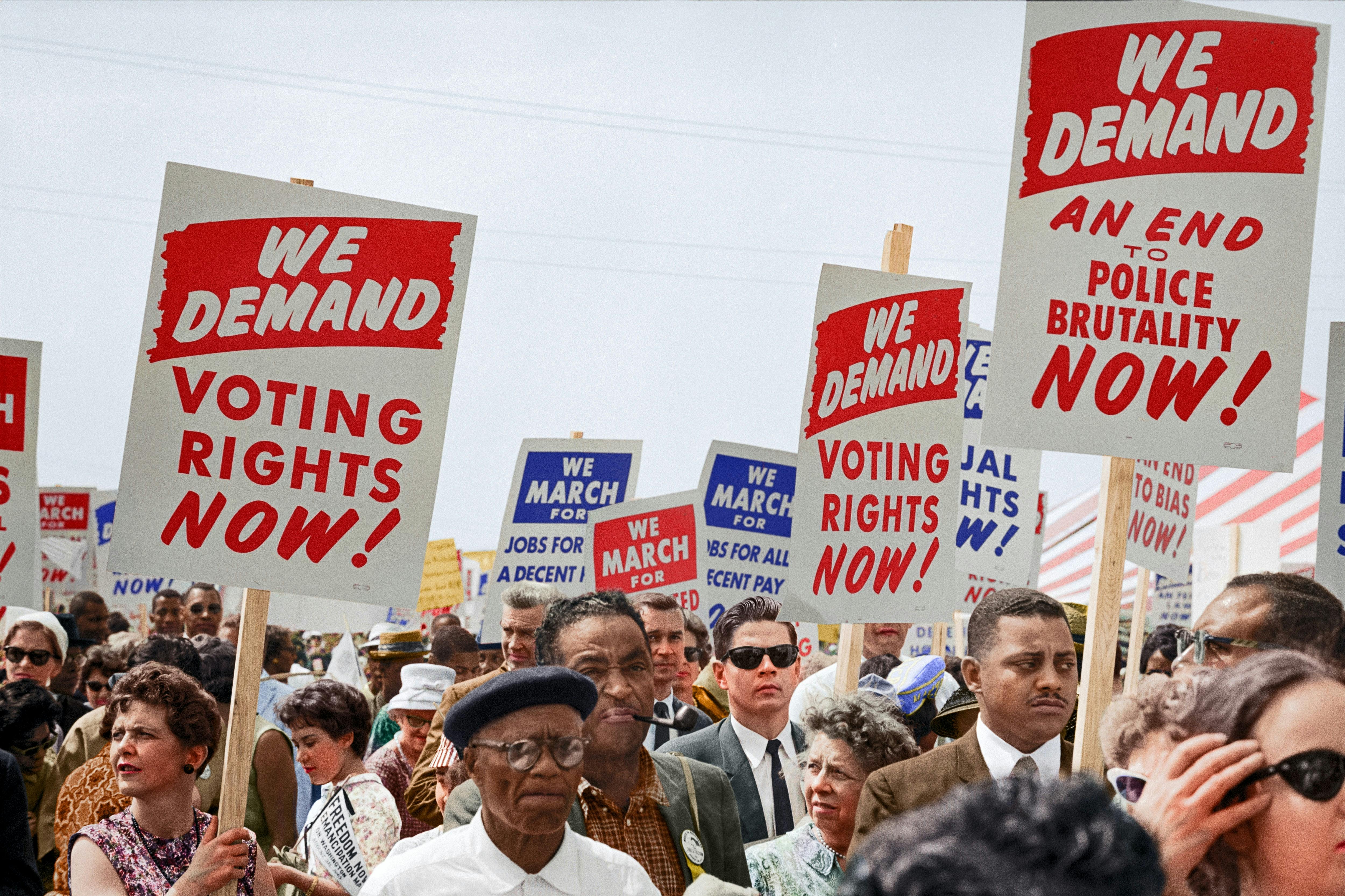 people holding signs saying "we demand voting rights now!" - Photo by Unseen Histories on Unsplash