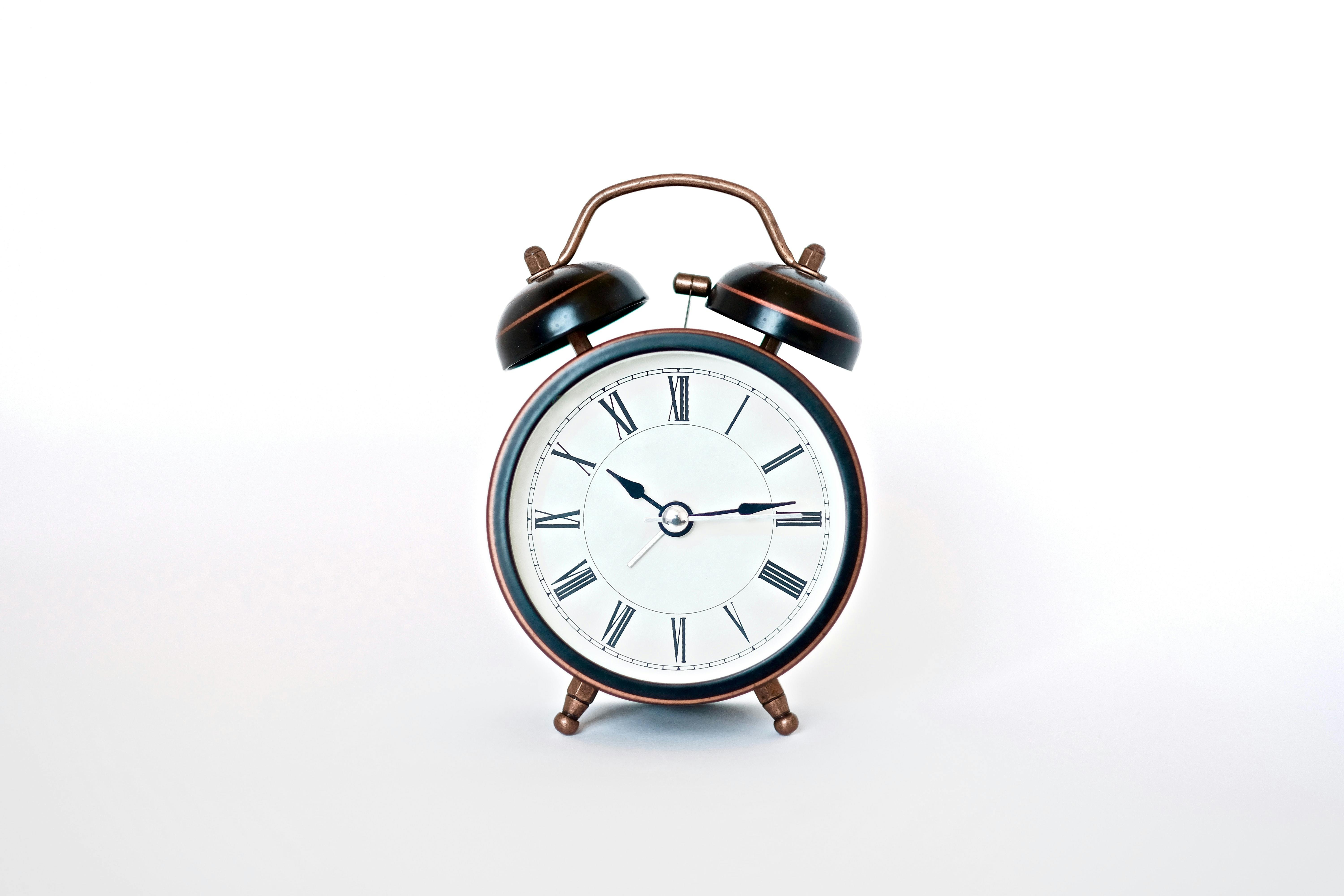 clock with a face and white background - Photo by insung yoon on Unsplash