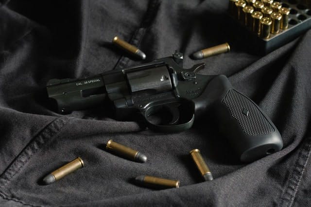 black and silver revolver pistol - Photo by Tom Def on Unsplash