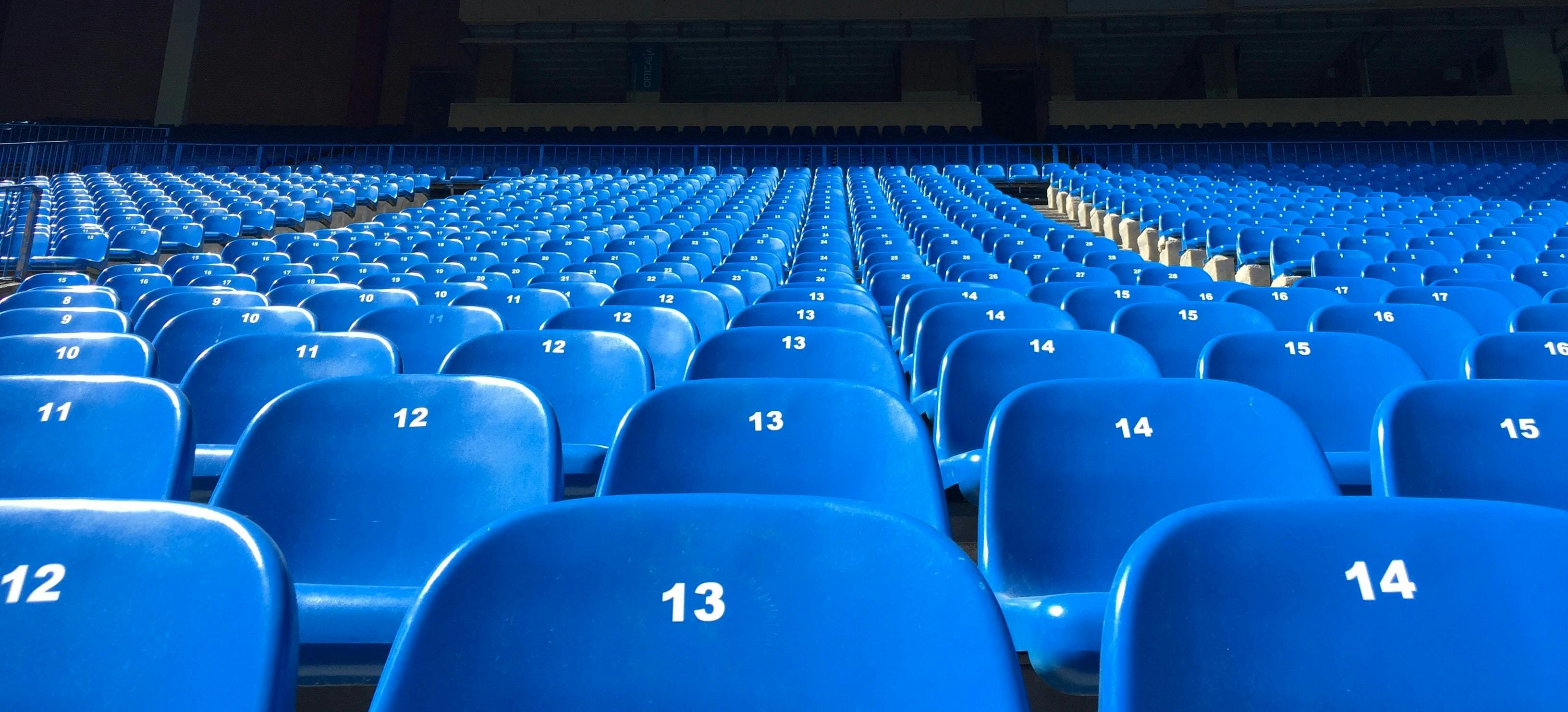 blue stadium seats - Photo by Florian Müller on Unsplash