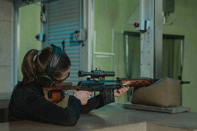 Woman shooting a rifle