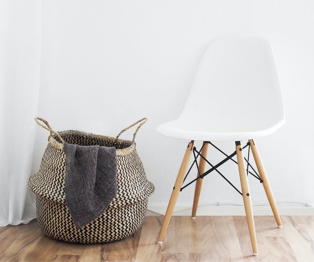 basket with blanket init and chair next to it - Photo by Sarah Dorweiler on Unsplash