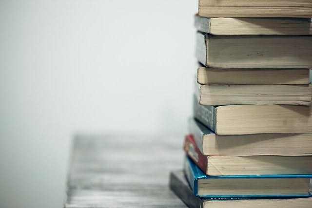 assorted books on wooden table - Photo by Alexander Grey on Unsplash