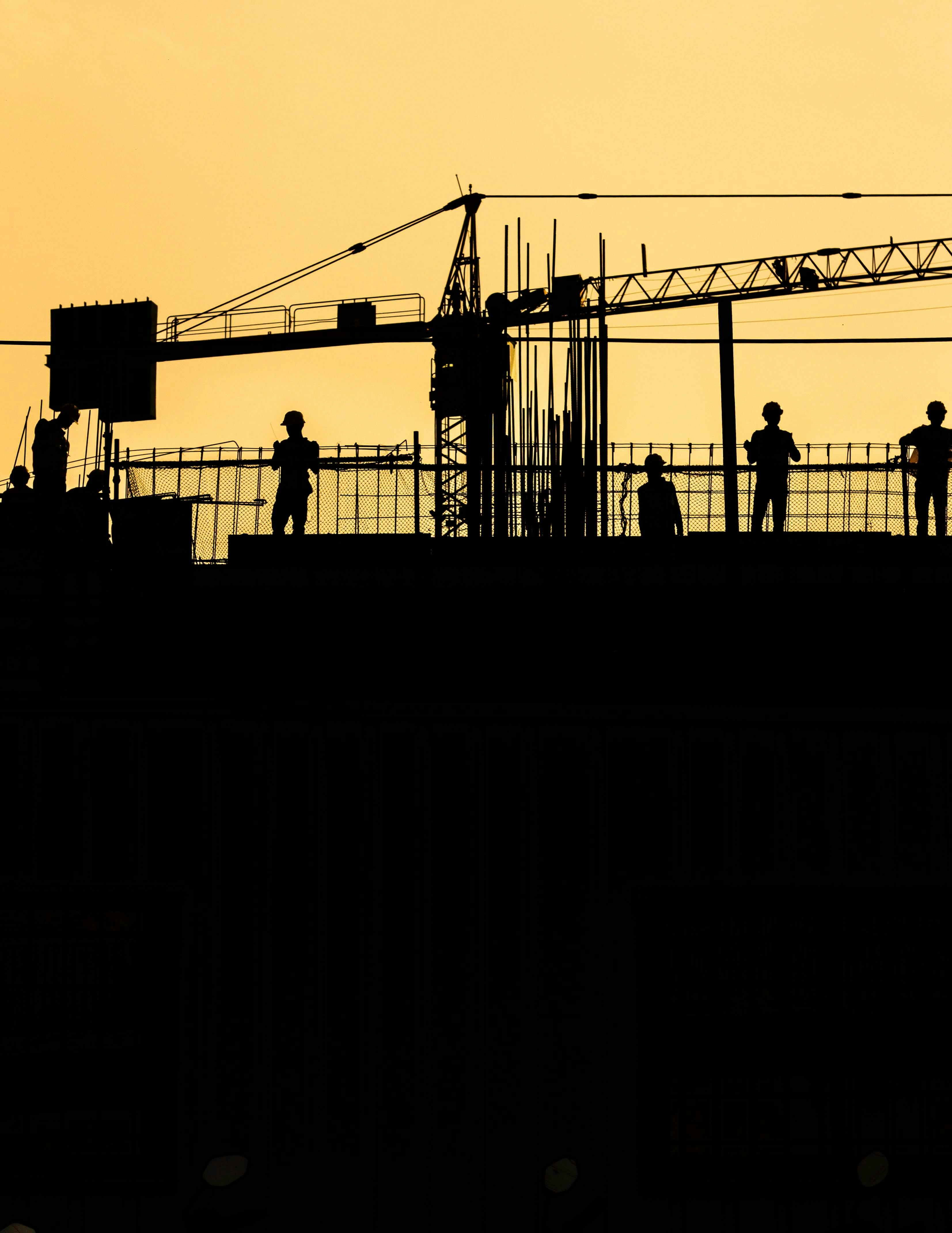 people working with hard hats silhouette - Photo by Shivendu Shukla on Unsplash