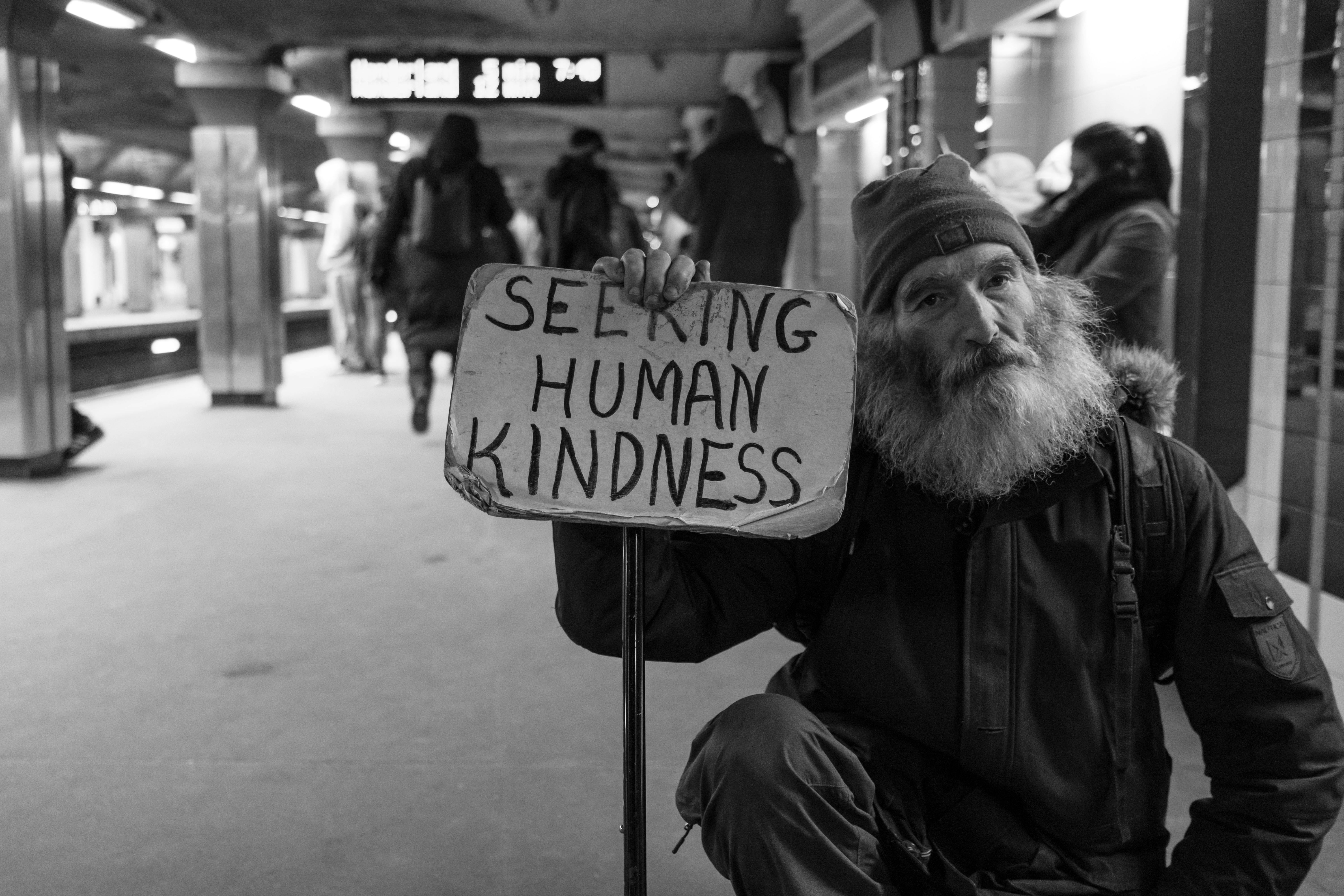 person holding sign saying "seeking human kindness" - Photo by Matt Collamer on Unsplash