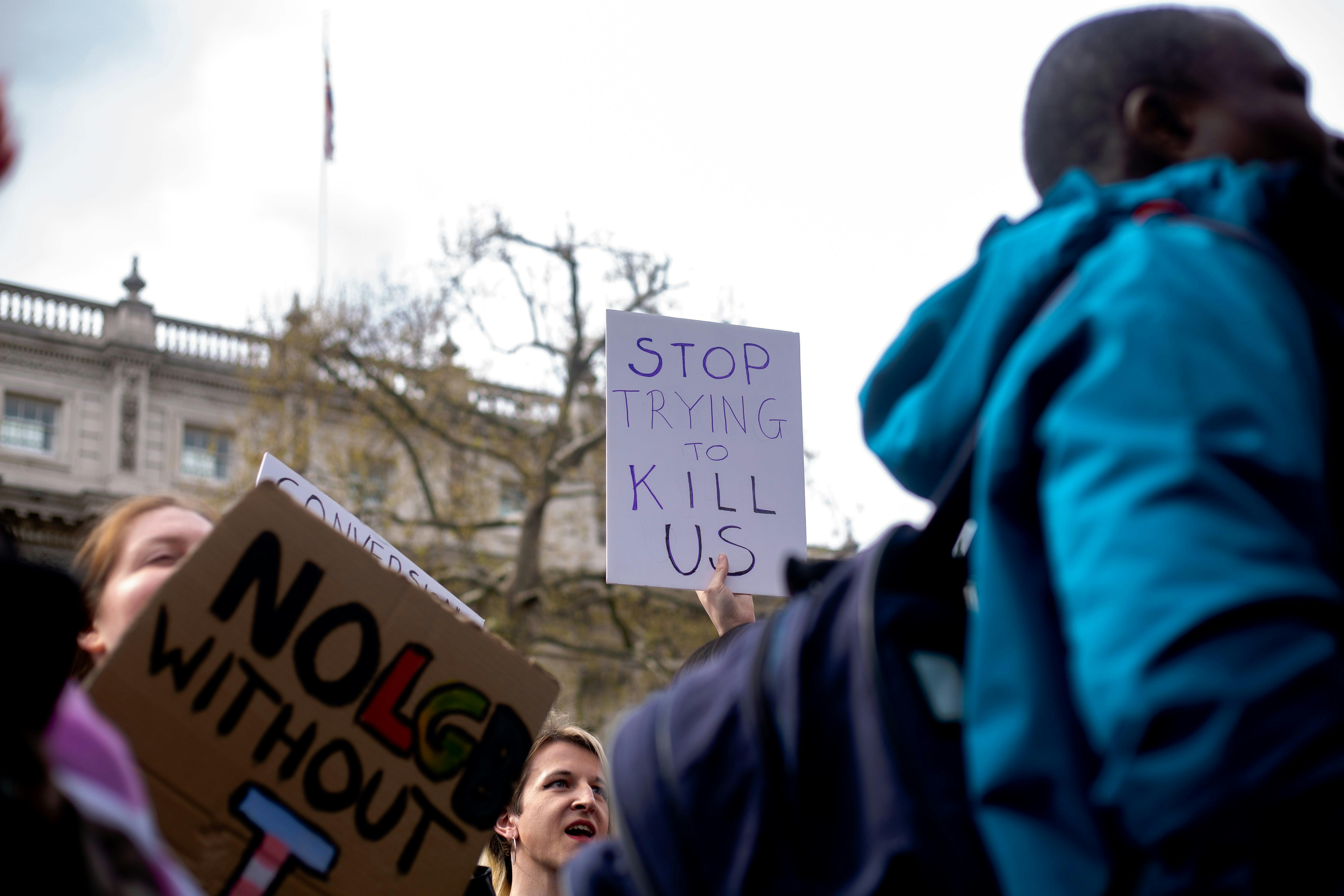 Someone holding a sign saying "stop trying to kill us" - Photo by Karollyne Hubert on Unsplash