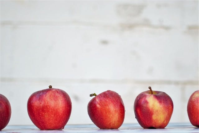 five red apples on white surface - Image from Isabella and Zsa Fischer on Unsplash