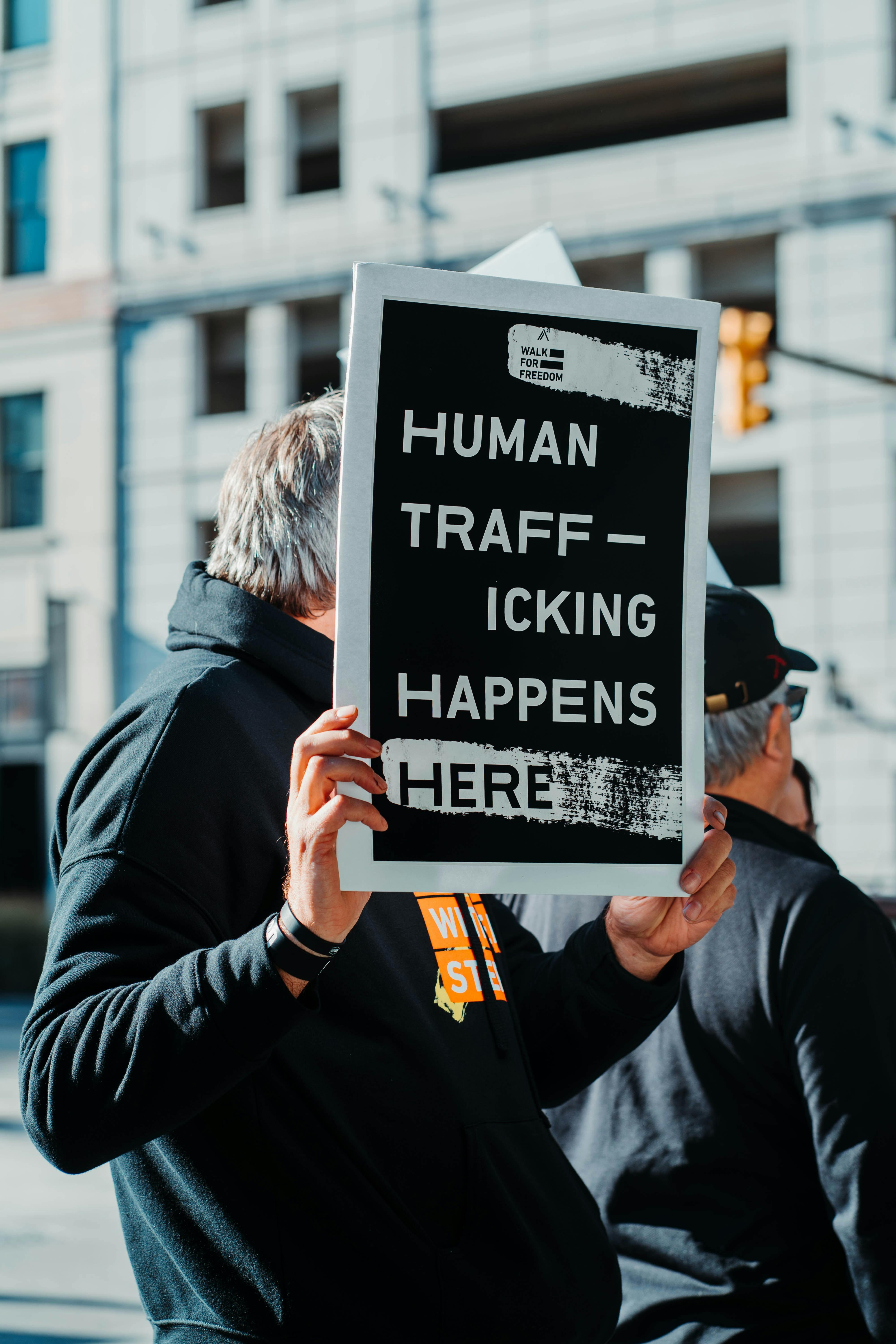 Human Trafficking Happens Here sign - Photo by Hermes Rivera on Unsplash